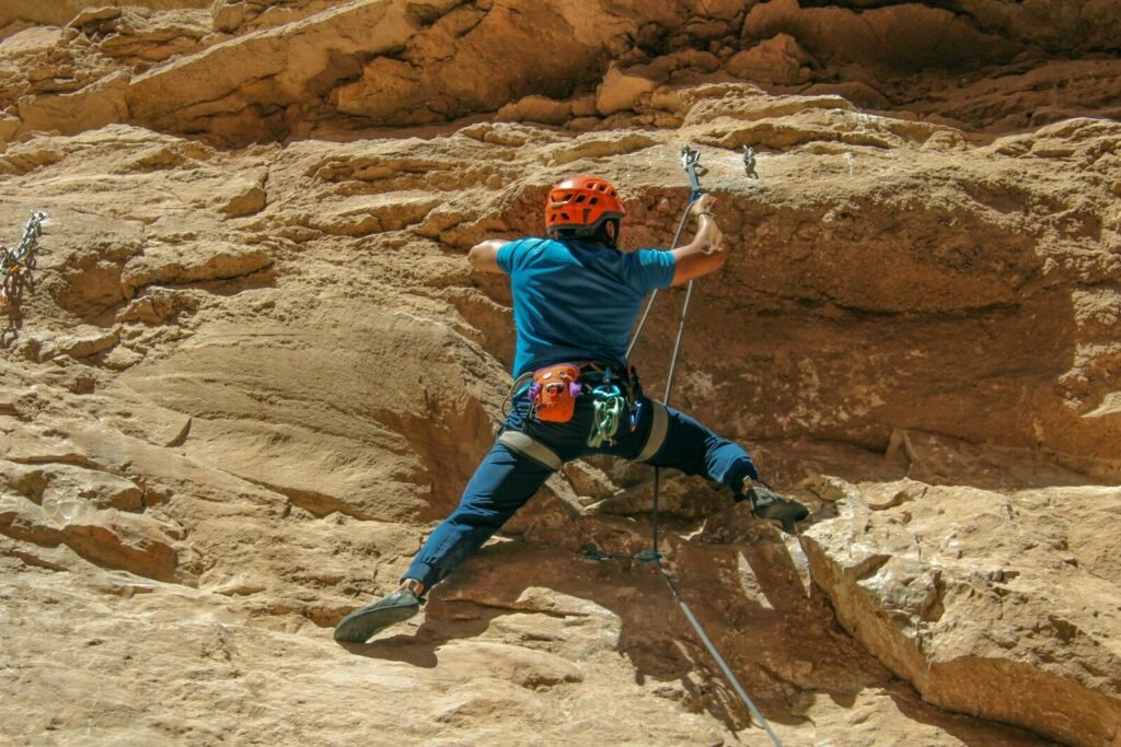 a man climbing up the side of a mountain